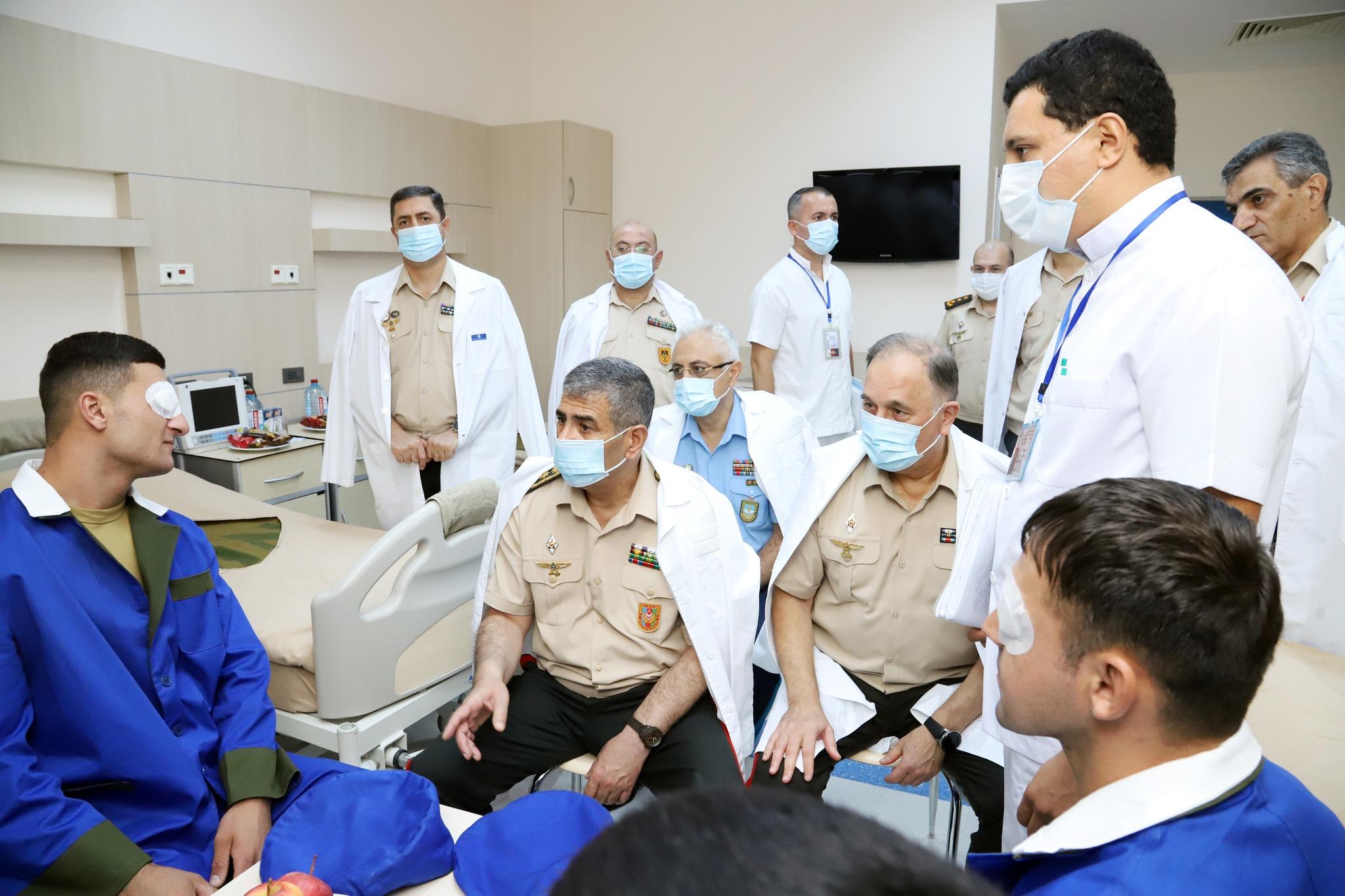 Azerbaijani Defence Minister Zakir Hasanov visiting soldiers injured during the two-day war of 2022. Image: Ministry of Defence.