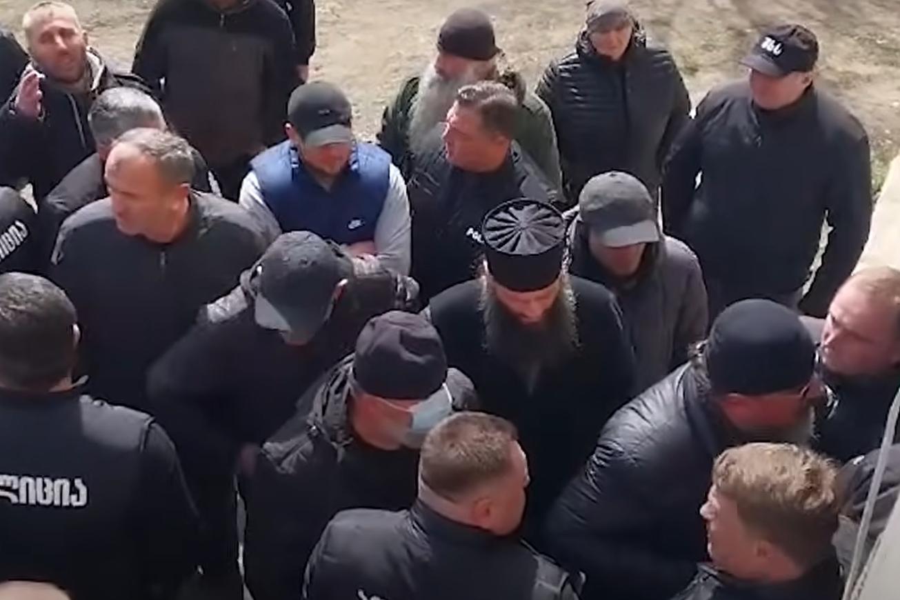 A mob led by Orthodox priests attempting to break into Imam Merab Mikeladze’s home to disrupt his prayer.